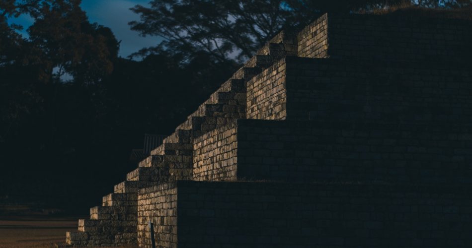 An image at night of one of the pyramids at Copan. Shutterstock.